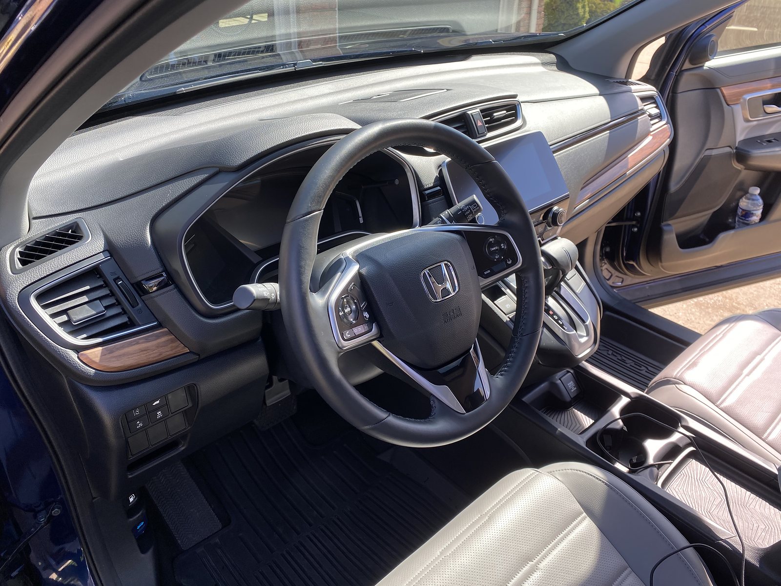 Freshly detailed car interior — clean seats, mats, and wood-trim dash